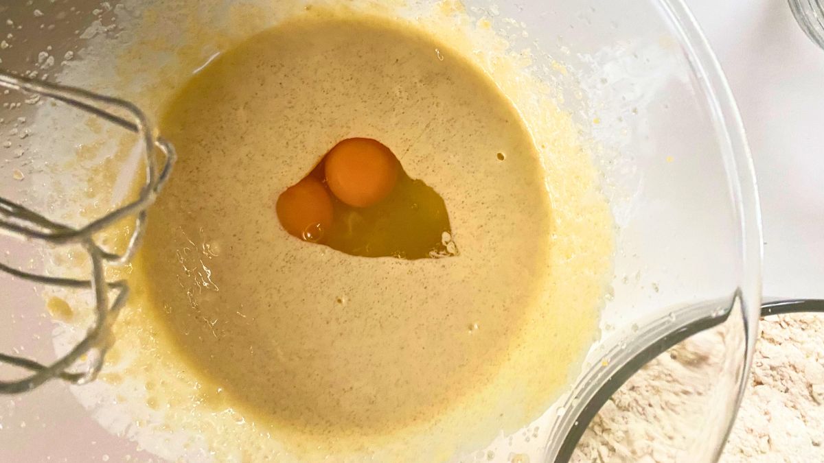A bowl of cookie mix with two raw eggs in it